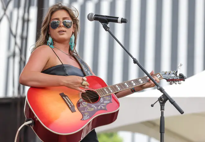 Ella Langley performing on stage with guitar