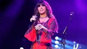 Ella Langley on stage in a red shirt while performing at the Omni Nashville Hotel in March 2026. - Ella Langley Duet Backlash