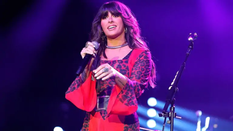 Ella Langley on stage in a red shirt while performing at the Omni Nashville Hotel in March 2026. - Ella Langley Duet Backlash