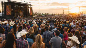 Golden hour crowd at an outdoor country music festival
